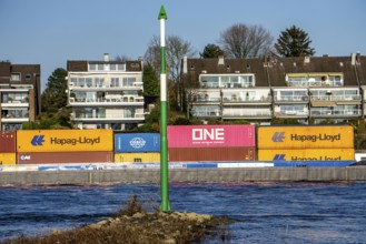 Container cargo ship on the Rhine near Düsseldorf-Bockum, villas on the banks of the Rhine, the