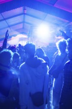 Dancing people at an atmospheric party with blue light effects, carnival, Schlagerkuchen Donzdorf,