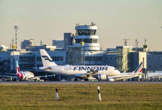 Finnair aircraft on the taxiway, apron of Düsseldorf International Airport, old air traffic control