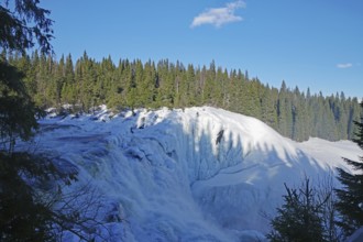 A frozen waterfall in a winter landscape with forest and clear sky, winter, Sweden's highest