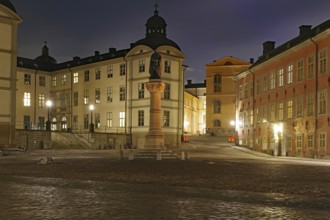 Illuminated historical square with monument at night, Old Town, Riddarholmen, Stockholm, Sweden,