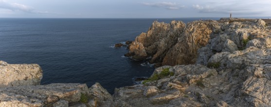 The tip of Pen Hir. The rocks are jagged and rough, the water is calm. The scenery is peaceful.