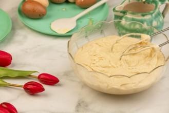 Finished dough in a bowl with ingredients in the background