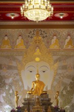 Golden Buddha statue with tunic, Bhumispara-mudra, Buddha Gautama at the moment of enlightenment,