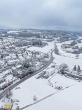 Snowy landscape with a main road through open fields, neighbouring forests, Aidlingen, Böblingen