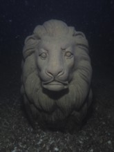 A lion statue under water with a mystical atmosphere, Wildsau dive site, Berlingen, Lake Constance,