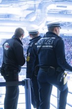 Police officers monitor stadium security during a sporting event, Heilbronner Falken Vs