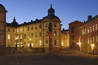 Evening atmosphere in a square with historic buildings and statue, Old Town, Riddarholmen,