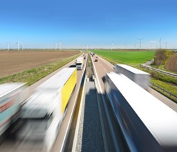 Motorway A38 near Querfurt, trucks and cars in motion blur, wind turbines on the horizon,