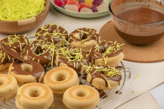 Donuts half dipped in chocolate, decorated with sprinkles