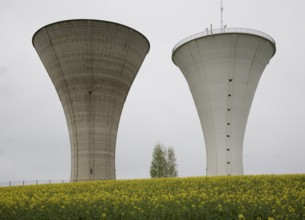 Bresse, 2 identical water towers next to each other in the rape field