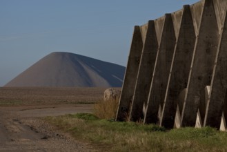 Copper slate mining spoil heap near Volkstedt, open concrete silo for acid feed on the right