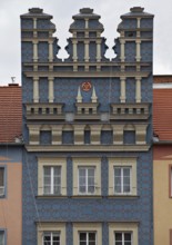 Renaissance ornamentation on a town house with town coat of arms consisting of three anchors