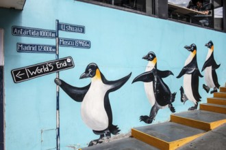 Milemarker as a mural with penguins, city centre, Ushuaia, Argentina, South America