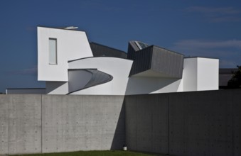 Frank O. Gehry, 1989, seen over a wall of the conference pavilion by Tadao Ando