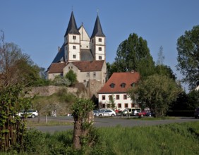 View of the village from the west with Romanesque double tower façade and west gable of the high