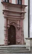 Renaissance portal from 1553 with seating niches, semicircular projections and double architrave