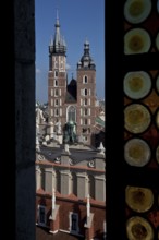 View through a coloured glass window of the town hall tower to St. Mary's Church, below Tuchhallen,