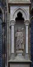 Sculpture of a king in the right buttress canopy on the north side of the three western nave bays,