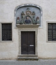 Portrait relief above the street entrance