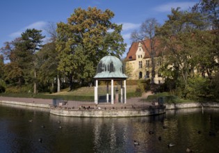 View across the pond to the pond arbour and castle