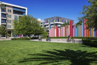 Cyclist in front of the Smith Centre with symphony installation Pipe Dream by Tim Bavington, Las