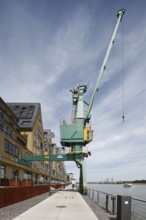 Historic Siebengebirge warehouse, converted into modern residential buildings, waterside with crane