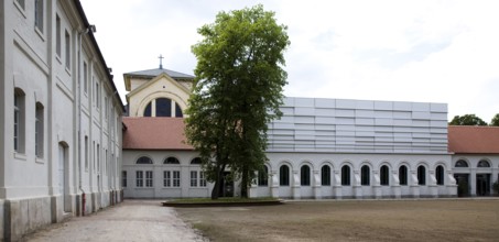 Concert hall in former riding arena, castle church behind it