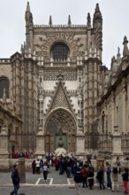 Seville, Cathedral. South portal in front of it Original of the bronze sculpture crowning the bell