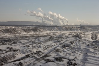 Landscape in the snow, power station in the background