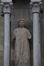 Sculpture of a youth in the central buttress canopy on the north side of the three western nave