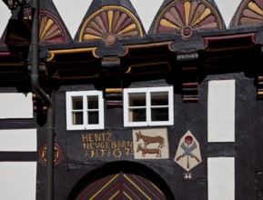 Former cookshop 1563, portal detail with relief symbols of cattle, cooking spoon and knife