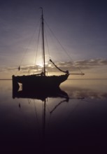 Wadden Sea, natural landscape. Sailing ship fell dry