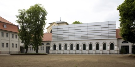 Concert hall in former riding arena, castle church behind it