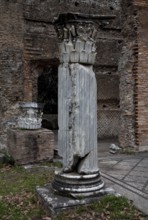 Column fragment in front of the triclinium