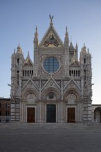 Siena, Duomo Santa Maria, cathedral square, view from the west at sunrise, sculptures on the façade