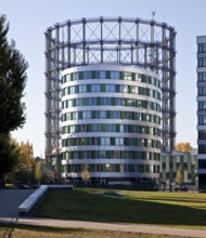 Office building 14 with elliptical floor plan from 2014, behind it Gasometer Schöneberg, in