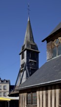 Free-standing tower from the end of the 15th century covered with chestnut wood shingles, nave on