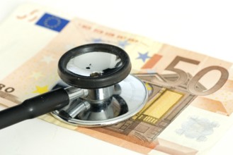 Stethoscope on fifty-euro note, sick currency, exchange rate, sick euro