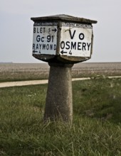 Historic concrete signpost, cube on column