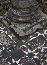 Column base on mosaic floor