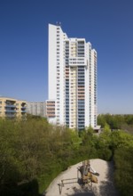 31-storey residential tower block by Walter Gropius, south side, playground in front between trees