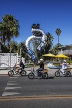 Cyclist in front of truck artwork, Fergusons Motel, Las Vegas, Nevada, USA, North America