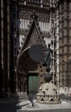 Seville, Cathedral. South portal in front of it Original of the bronze sculpture crowning the bell