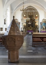 View to the east with late Gothic baptismal font from 1559 with reference to Father Josef