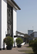 Butzweilerhof, reception building from 1936 with eagle, tower in the background