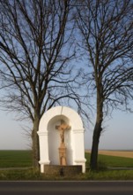 Wayside shrine from the 18th century flanked by two lime trees