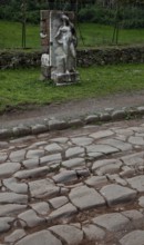 Stele of a naked youth in front of an antique pavement