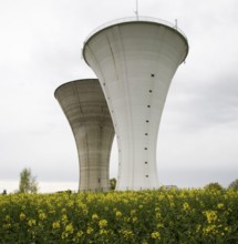 Bresse, 2 identical water towers one behind the other in the rape field