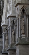 Sculptures of a crowned virgin, a youth and a king in the buttress canopies on the north side of